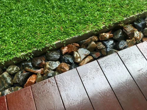 Layered crushed-stone base prepared under artificial turf
